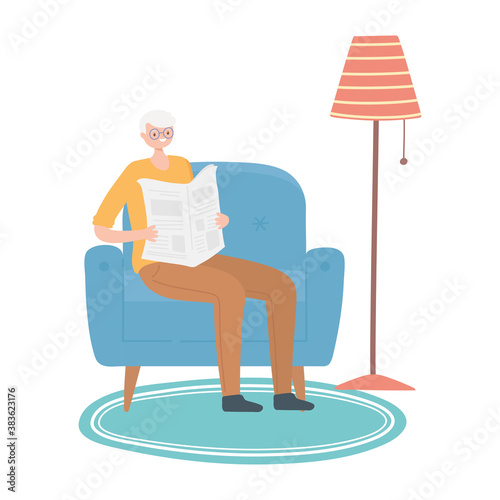 activity seniors, elderly man in living room reading newspaper