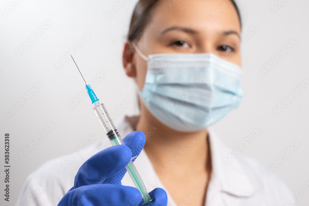 doctor in gloves and a mask with a syringe. vaccination against coronavirus covid-19 doctor in gloves and a mask with a syringe. vaccination against coronavirus covid-19
