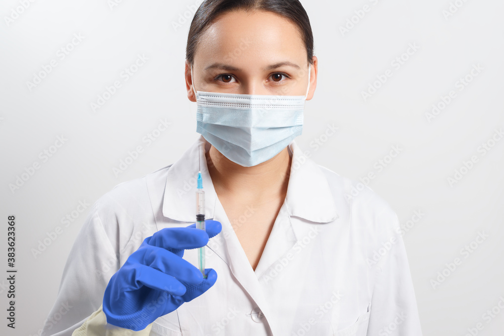 doctor in gloves and a mask with a syringe. vaccination against coronavirus covid-19 doctor in gloves and a mask with a syringe. vaccination against coronavirus covid-19