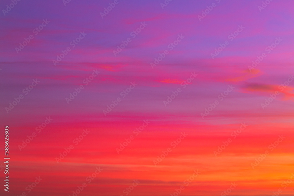 Purple and orange pastel coloured sky with clouds at sunrise