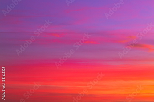 Purple and orange pastel coloured sky with clouds at sunrise