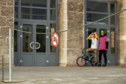 Wallpaper Mural Red bike stop sign on street and urban extreme bmx bikerson the background. Torontodigital.ca