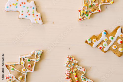 Christmas background - gingerbreads in the shape of a Christmas tree point to the center like arrows. Empty space for text in the center.