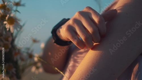 girl holds her hand forearm with goosebumps at dawn holding bouquet of daisies