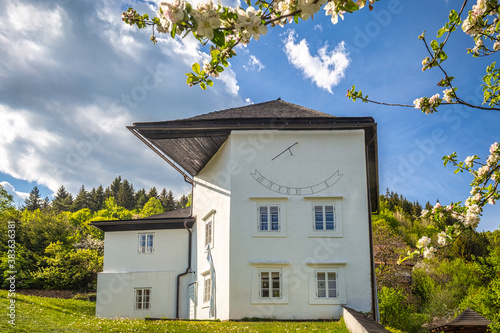 Historic building with sundial in The Spania Dolina village, Slovakia, Europe.