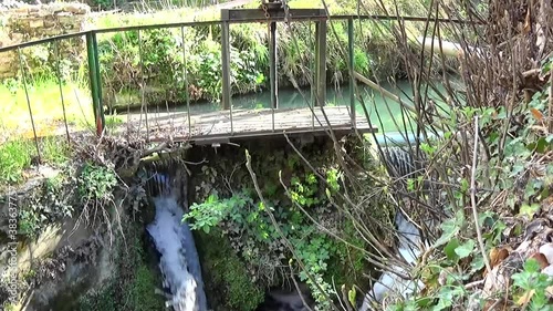 Weir with little waterfall on a stream in Tuscany countryside