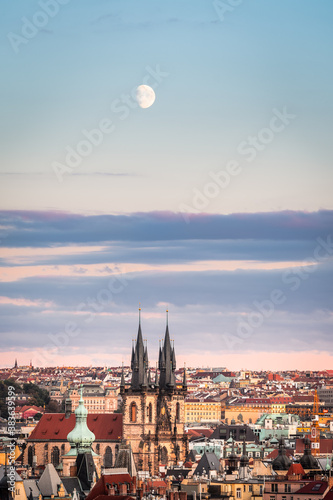 Rising moon during sunset on still blue sky over the Church of our Lady before Tyn, Prague, Czech Republic