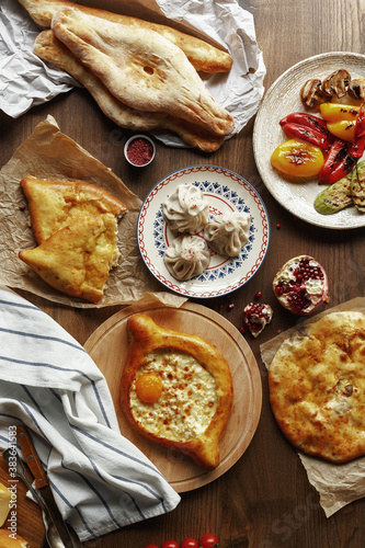 dishes and snacks of traditional Caucasian Georgian cuisine. classic national serving on a rustic wooden table