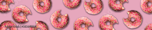 pattern. donuts in pink glaze and topping are laid out on a pink background.space for text