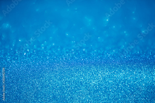blue glitter texture christmas abstract background with bokeh