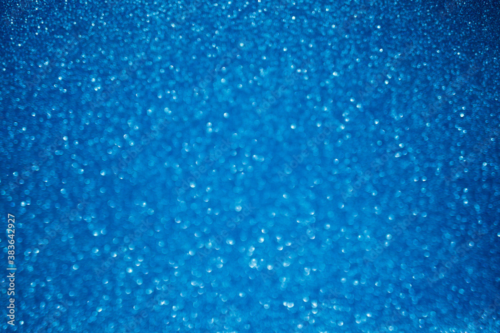 blue glitter texture christmas abstract background with bokeh