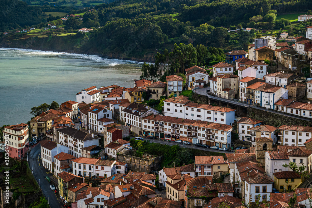 Picturesque coastal landscape. White houses on a cliff. Small fishing village of Llastres in Asturias, Costa Verde, Spain.