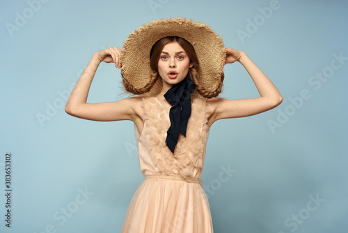 Girl in a pink dress on a blue background gestures with her hands romance model fun emotions cropped view