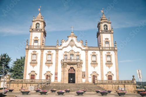 large and high church with two bell towers. Wide area in front of the church. architecture of churches in portugal photo