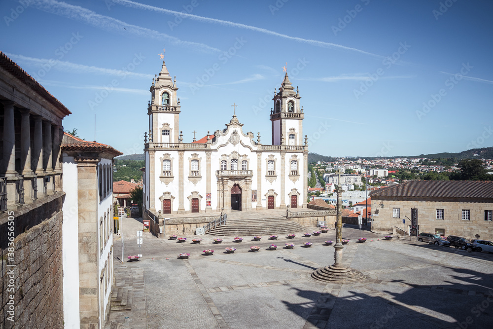large and high church with two bell towers. Wide area in front of the church. architecture of churches in portugal