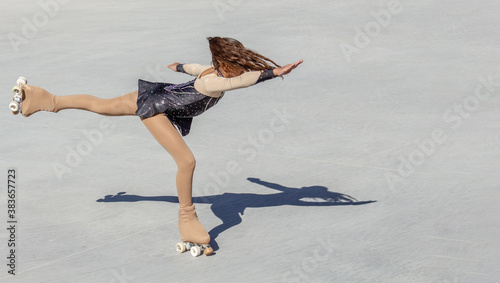 Photography Teenage girl performing figure skating on wheels
