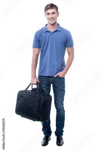 Smiling man standing with bag photo