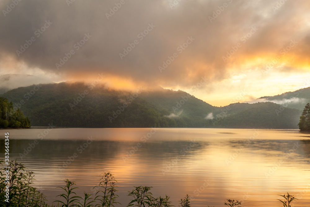 Beautiful sunset behind mountains on a lake in the Smokies in North Carolina