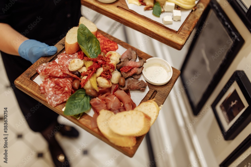 Food tray with delicious salami, pieces of sliced ham, sausage, olives - Meat platter with selection