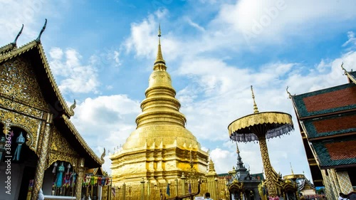 Time lapse of golden pagoda in Wat prataj  Hariphunchai  , Lamphun  province in northern Thailand. photo