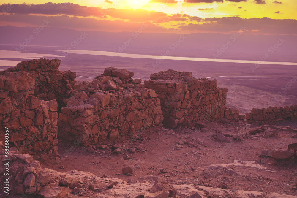 Beautiful purple sunrise over Masada fortress. Ruins of King Herod's palace in the Judaean Desert. Dead sea region