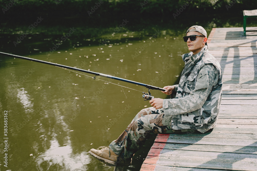 A man fishing on a lake. Guy in a uniform. A man fishing on a lake. Guy in a uniform.