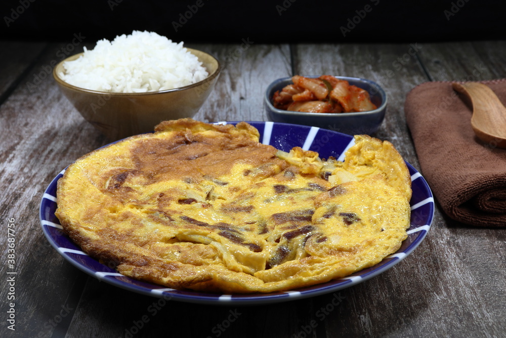 Fried egg with sliced onion and pork sausage on the plate. Famous breakfast set menu in Asia restaurant. Fried egg with sliced onion and pork sausage on the plate. Famous breakfast set menu in Asia restaurant.