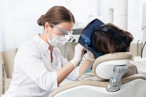 A close up picture of the process of modern dental treatment, with the use of modern technologies.