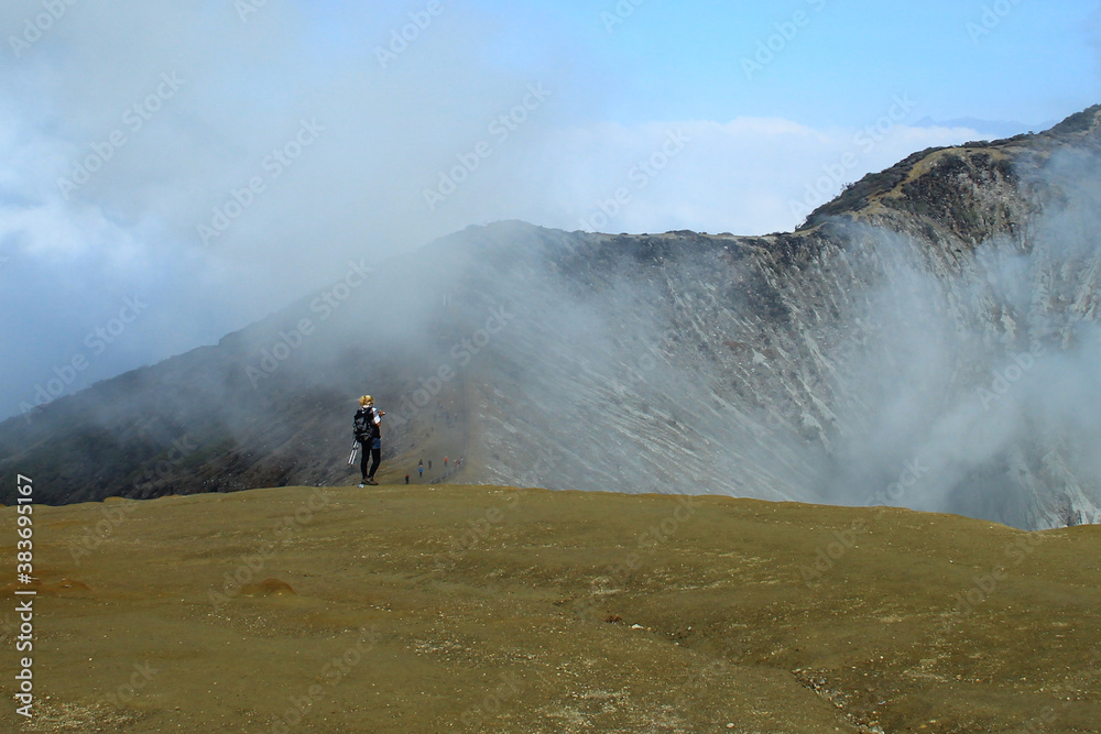A woman walk at the top of Ijen Crater Banyuwangi East Java Indonesia