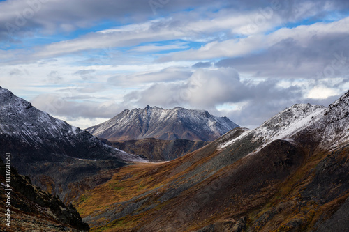 Beautiful View of Scenic Mountains and Landscape in Canadian Nature. Season change from Fall to Winter. Taken in Tombstone Territorial Park, Yukon, Canada.