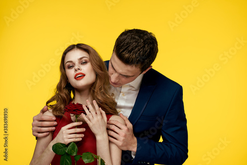 Gentlemen in classic suit on yellow background and red rose romance cropped view model portrait.