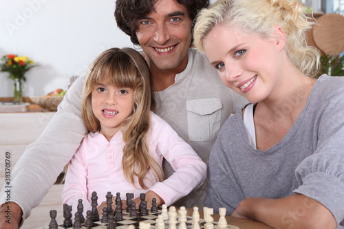 Family playing chess together photo