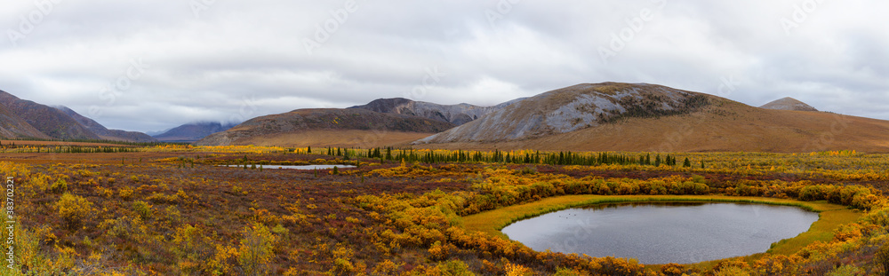 Beautiful Panoramic View of Scenic Lake on a Fall Day in Canadian Nature. Taken near Tombstone Territorial Park, Yukon, Canada. Beautiful Panoramic View of Scenic Lake on a Fall Day in Canadian Nature. Taken near Tombstone Territorial Park, Yukon, Canada.