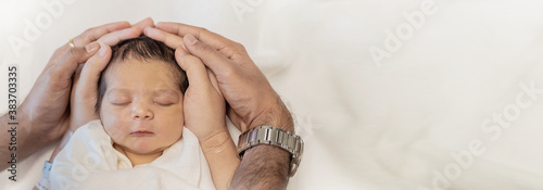 Close up father and mother hands holding newborn baby, copy space background banner family parents love concept photo