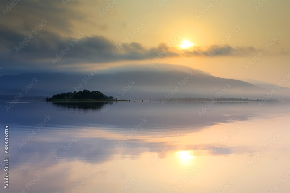 Light morning with fog on the lake at sunrise