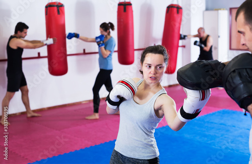 Young athlete girl training boxing sparring at box class © JackF