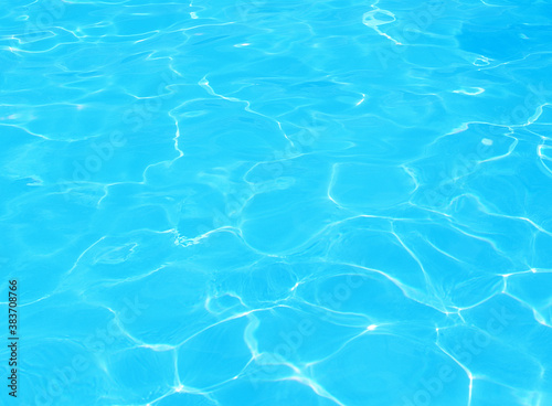 Surface of blue swimming pool, background of water in swimming pool. Abstract beautiful ripple wave and clear turquoise water surface in swimming pool, Turquoise or blue water wave for background