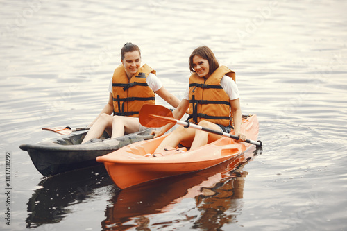 Kayaking. A women in a kayak. Girls paddling in the water. © hetmanstock2