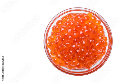 Salmon Red Caviar. Red fish caviar in glass bowl. Raw seafood. Luxury Russian delicacy food. White isolated background. Flat lay, top view. Copy space.