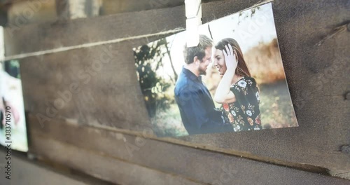 A printed engagement photo hung on a clothes line as decor for a rustic weddings