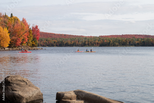 Autumnal view of a group of kayakers on a lake in the Frontenac national park, Canada
