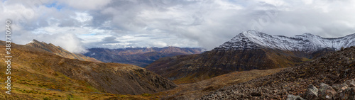 Panoramic View of Scenic Landscape and Mountains in Canadian Nature. Season change from Fall to Winter. Taken near Grizzly Lake in Tombstone Territorial Park, Yukon, Canada. © edb3_16