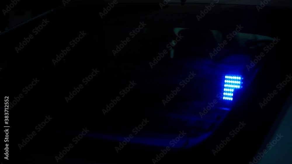 Red Police Sign And Blue LED Lights Behind Car Windscreen. Follow Shot Red Police Sign And Blue LED Lights Behind Car Windscreen. Follow Shot