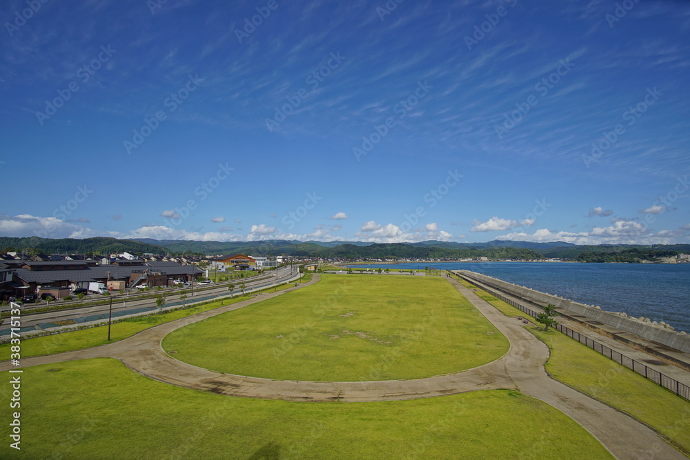 Green park near sea front with ocean on the background. Toyama, Japan.