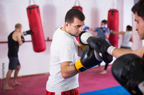Portrait of two athlete men practicing boxing sparring at box class © JackF