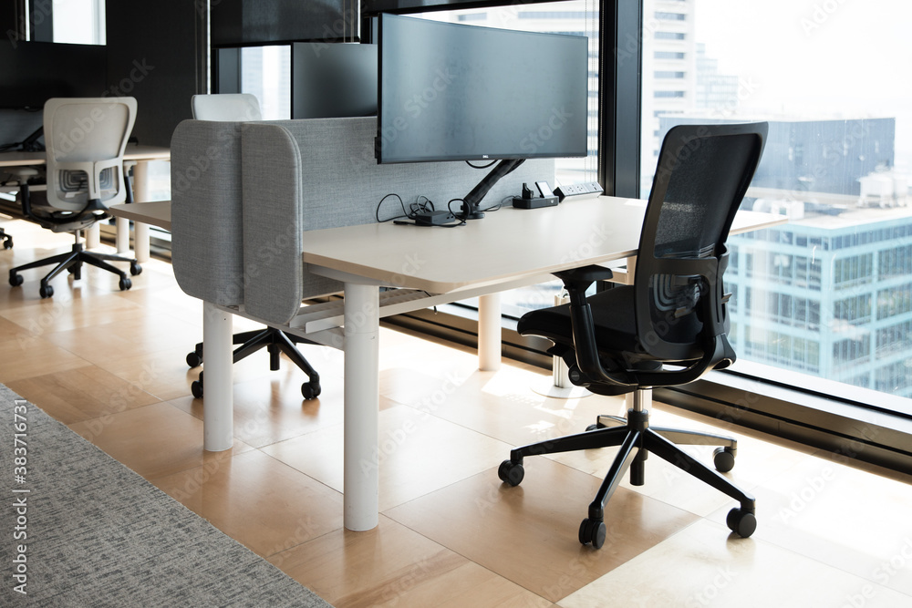 Modern flexible office work space interior fitout rows desks chairs floor cieiling windows T5 lights computer stations screens cityview	