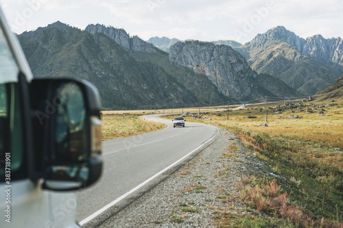 Parked car on auto road against beautiful mountain landscape, Chemalsky tract, Altai