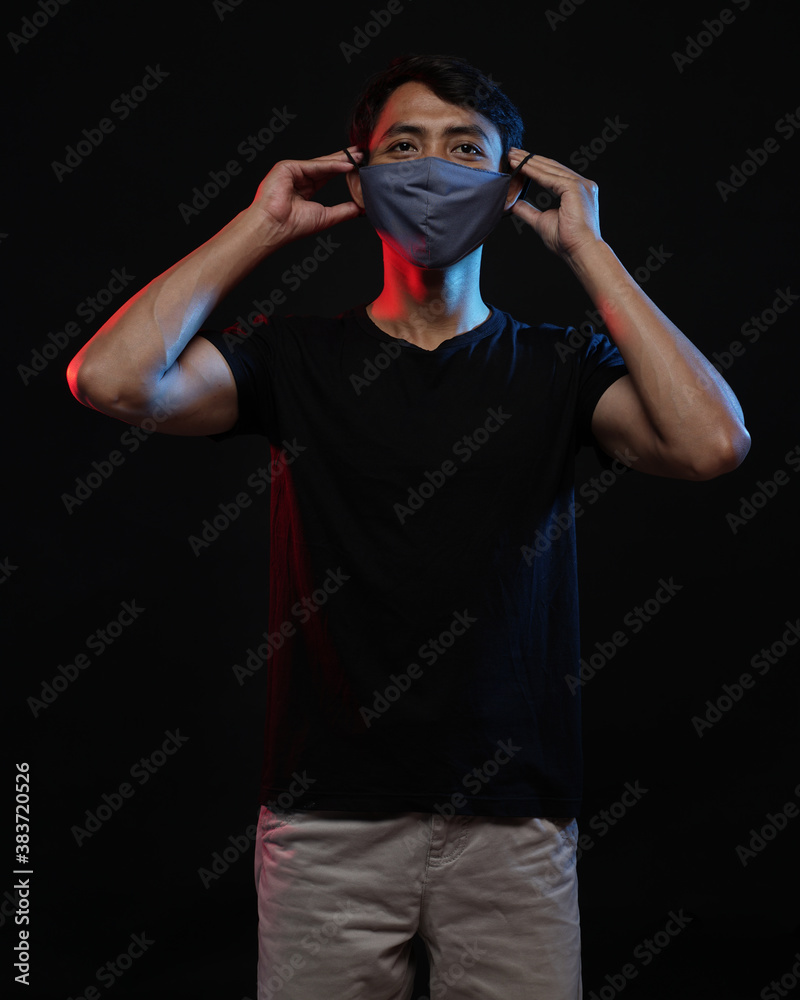 Young men in empty black T-shirts and wearing health masks, dress up and pose like famous T-shirt models. Men's t-shirt template and mockup design for print. Young men in empty black T-shirts and wearing health masks, dress up and pose like famous T-shirt models. Men's t-shirt template and mockup design for print.
