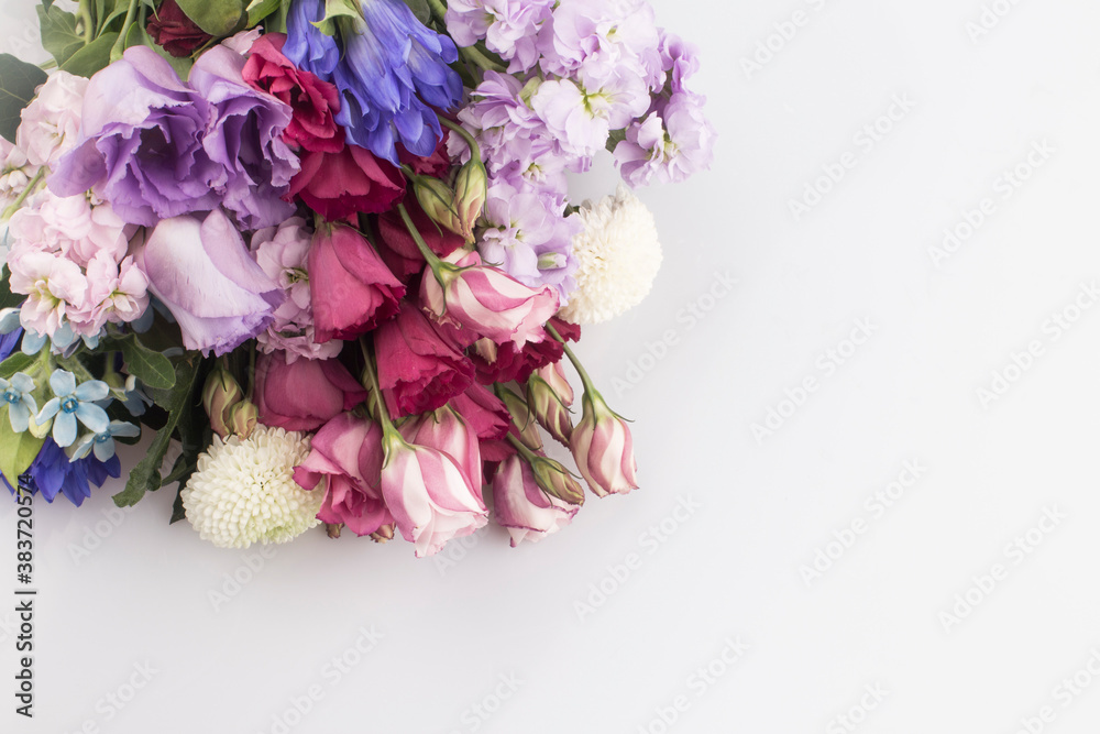 bouquet of pink and violet lisianthus flowers on white background.