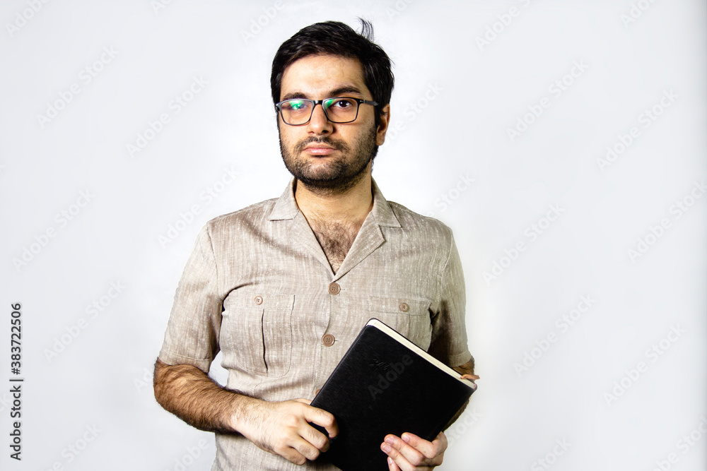 A young lecturer holding a book in hands A young lecturer holding a book in hands